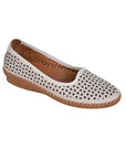 White ballet flat shoe with cutouts and brown outsole.