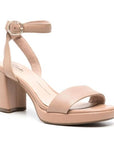 Beige ankle strap block heel with silver buckle and single strap across the open toe. Footbbed is light cream color with Clarks logo printed. Outsole is a dark brown rubber 