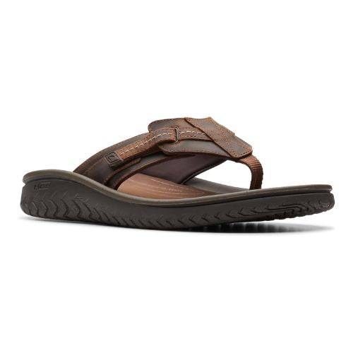 Brown leather thong sandal with fabric toe post and adjustable strap. 