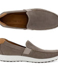 A pair of Ecco grey nubuck slip-ons with a white midsole. Upper has perforations and apron stitching. 