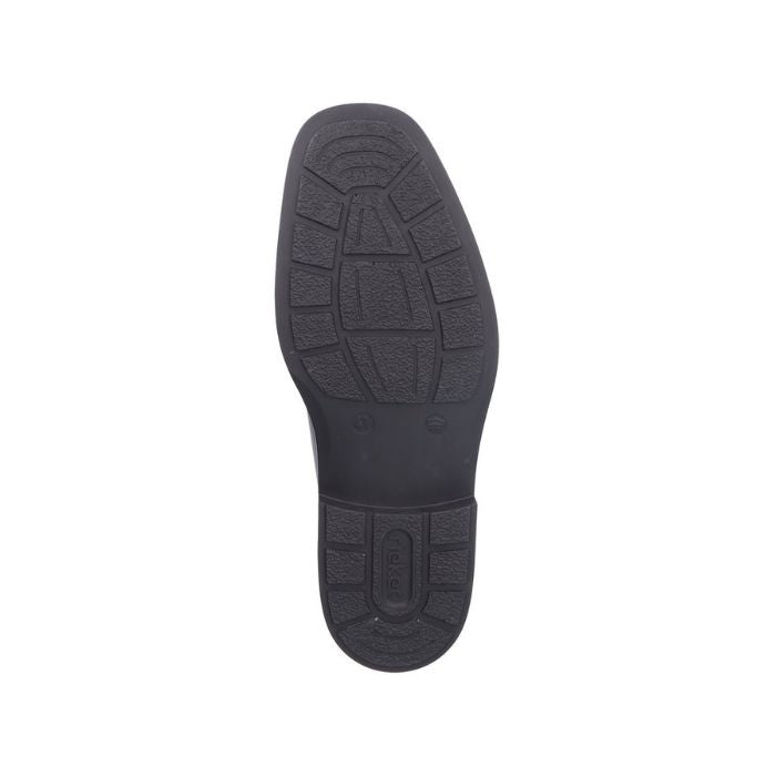 Black rubber outsole of dress boot with Rieker logo on heel.