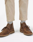 Man in beige pants and grey socks wearing the Desert Boot EVO. 