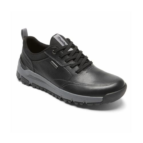 Black leather sneaker with waterproof icon near side of black laces. Grey Dunahm tag on tounge of shoe. The midsole is a thick sporty shape grey with black tred outsole. There is a low black rubber toe bumper