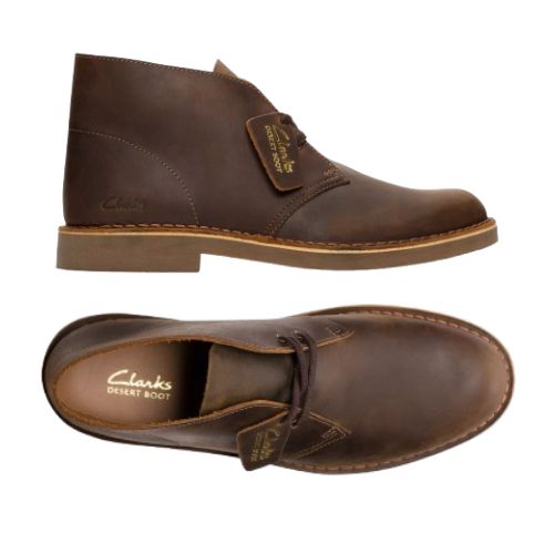 Top and side view of Beeswax brown desert boot with leather tag showing the Clark's logo and Desert Boot name. Dark brown laces, light brown outsole and tan stitching line between upper and outsole