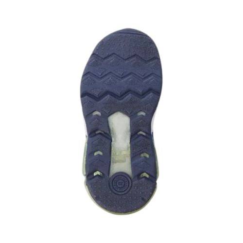 Bottom view of a navy blue shoe sole with zigzag tread and a flexible rubber outsole on a white background.