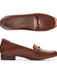 Top and profile view of Juliet Shine in tan. Features low stacked heel and apron stitching at toe. 