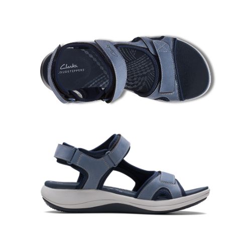 Profile and top view of Blue walking sandal with Velcro on heel, toe and ankle strapes. Dark blue lining with lighter blue on the upper for contrast look. Light grey thick midsole and black rocker rubber outsole. Dark blue footbed with light blue Clarks logo and wave like designs