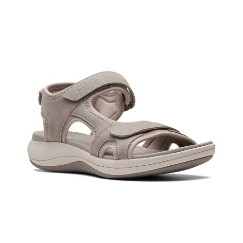 Stone color walking sandal with Velcro on heel, toe and ankle strapes. Light beige thick midsole and darker beige rocker rubber outsole