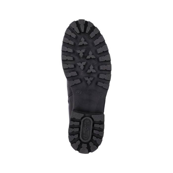 Black lugged outsole of women's boot with Remonte logo on heel.