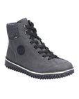 A Rieker grey suede sneaker boot with black laces, circle logo on side and black aggressive tread.