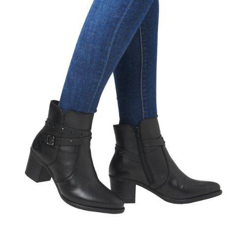 Women in blue jeans wearing black dressier block heel boots with studded ankle straps.