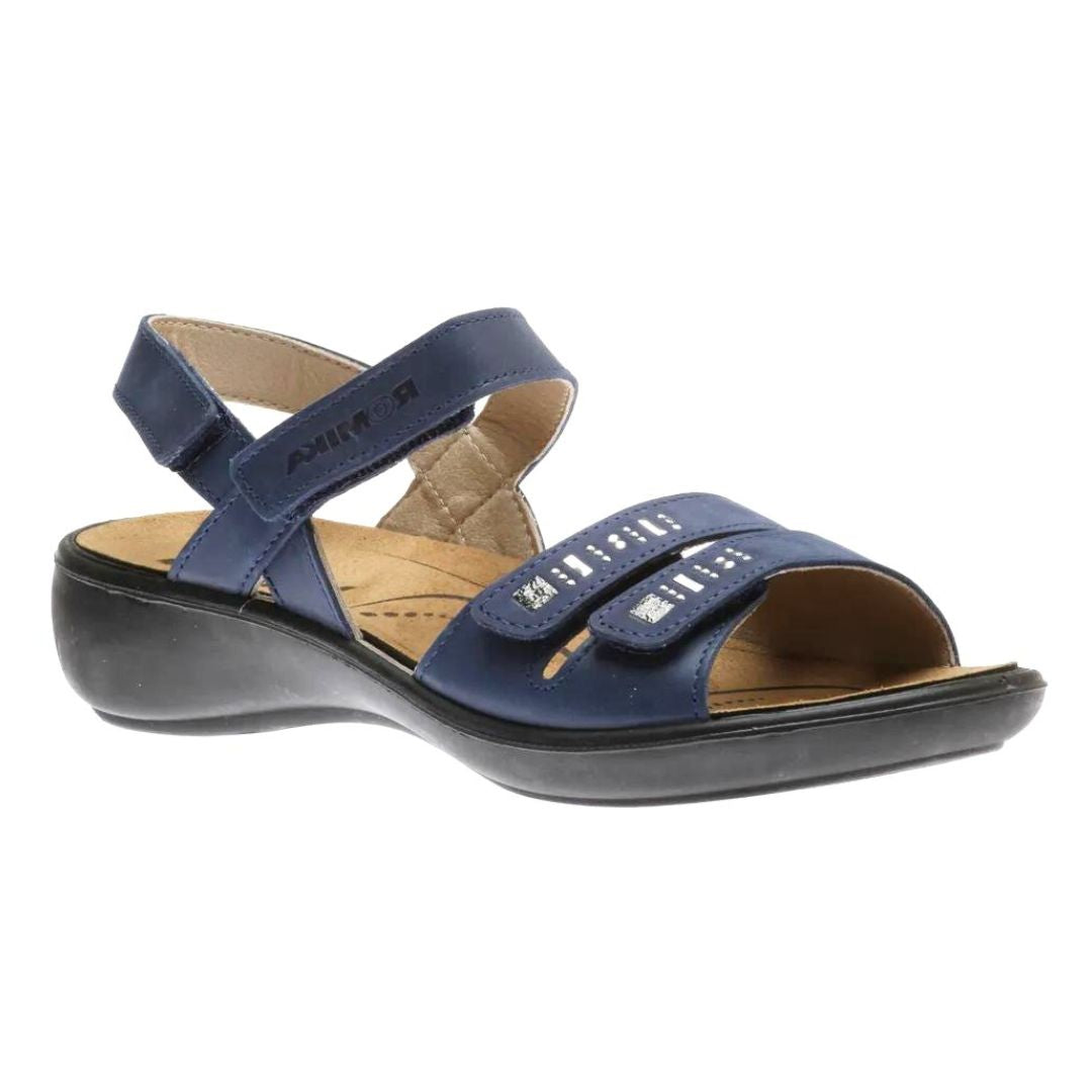 Navy Josef Seibel Ibiza sandal with adjustable straps, decorative metal accents, and a removable footbed.