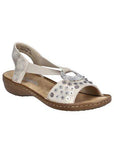 Rieker gold sling back sandal with circle medallion on top of floral sequined toe strap and a beige footbed and brown outsole.