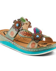 Multicoloured teal and beige slide sandal with floral covered straps. Footbed is beige, midsole is blue, outsole is white. 