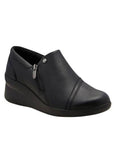 Black leather wedge ankle slip-on shoe. Has a detailed silver button above side zipper. Small detailed diagonal stitching on toe.