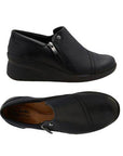 Top and Profile of Black leather wedge ankle slip-on shoe. Has a detailed silver button above side zipper. Small detailed diagonal stitching on toe. Padded tan footbed has the black Clarks logo at heel