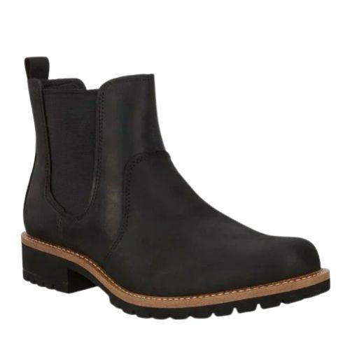 An Ecco black leather chelsea boot with elastic goring, black heel tab, light brown mid-sole, with low heel black outsole. 