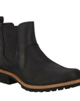 An Ecco black leather chelsea boot with elastic goring, black heel tab, light brown mid-sole, with low heel black outsole. 