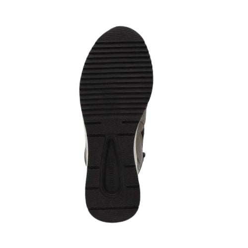 Black outsole of the wedge sneaker showing tread lines and Remonte logo at heel