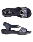 Pair of Rieker navy sling back sandal with circle medallion on top of floral sequined toe strap and a black footbed and outsole.