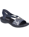 Rieker navy sling back sandal with circle medallion on top of floral sequined toe strap and a black footbed and outsole.