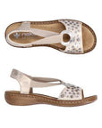 Pair of Rieker gold sling back sandal with circle medallion on top of floral sequined toe strap and a beige footbed and brown outsole.