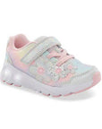 Rainbow childrens sneaker with pastel tie-dye, floral accents, a pink sole, memory foam footbed, and a Velcro strap.