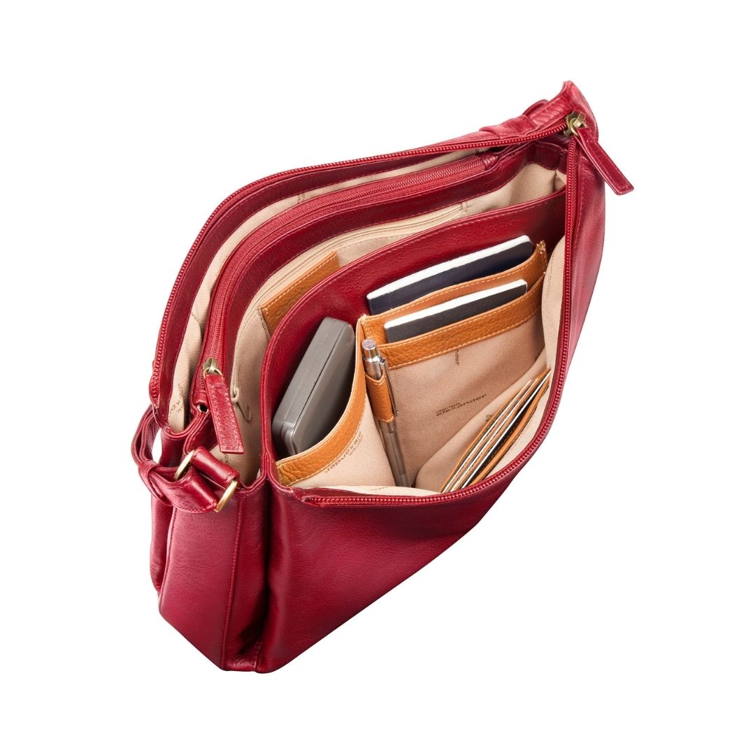 Inside view of red leather handbag with lots of storage space, pocktets, card sleeves and zippers.