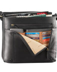 Black leather messenger bag with front compartment opened, displaying multiple card slots, a cell phone, and a notebook placed inside the various pockets. Inside the main compartment is a notebook and some magazines. 