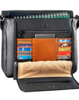 Interior of black handbag, revealing brown leather accents, multiple card holders, two zippered pockets, and space for a notebook. 