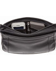 Inside view of black leather handbag with adjustable strap holding pen, wallet and cell phone.