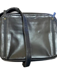 Black leather bag with zippers running vertically down on each side, as well as a zipper along the top for the main compartment. 