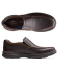 Top and side view of brown leather slip-on shoe with bicycle toe stitching. Clarks logo on heel of insole.