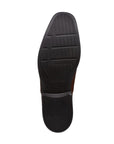 Outsole of Clarkslite Ave slip on in tan. Black rubber outsole, textured for grip, with Clarks logo. 