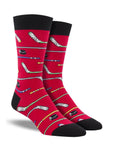 A pair of red crew socks with hockey sticks on them.