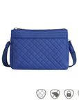 Blue quilted crossbody bag. Anti-theft symbols on bottom.