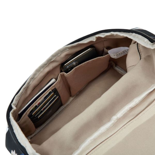 Inside view of Travelon backpack with beige lining. Bag is holding lots of cards, a passport and cellphone.