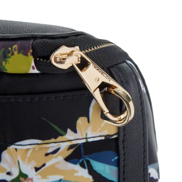 Gold zipper closure on a black floral Travelon backpack.