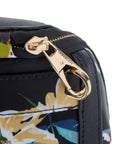 Gold zipper closure on a black floral Travelon backpack.