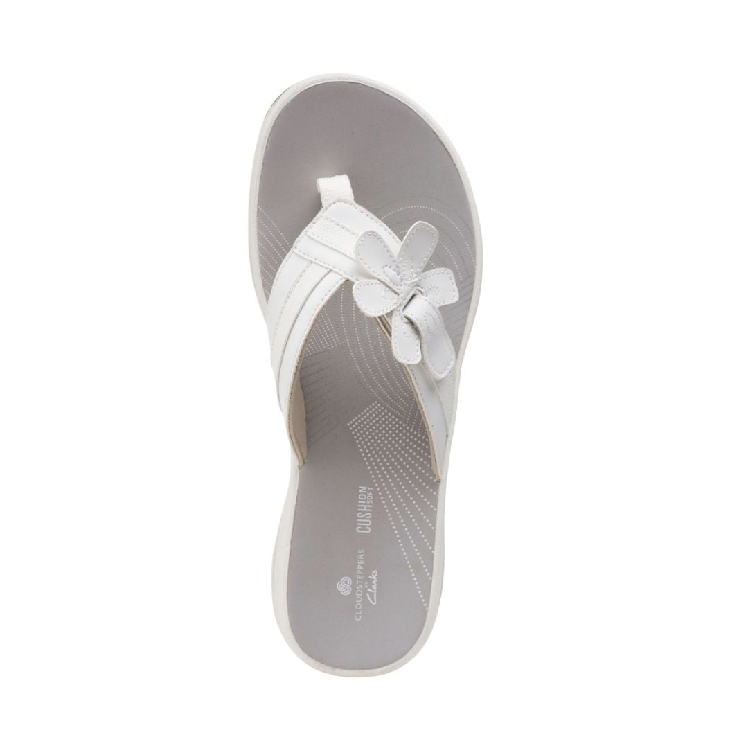 Top view of Breeze Flora thong sandal in white. Grey footbed has Clarks branding. 