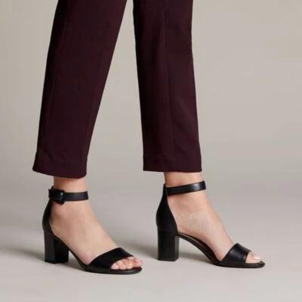 Woman in purple trousers wearing the Deva Mae heeled sandal in black.