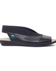 Caliber sandal in black. Black leather upper with elastic backstrap and peep toe cutout. Very low wedge outsole.