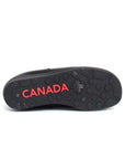 Black rubber outsole with maple leaf pattern and red "Canada" text embossed. 