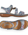 Blue multi sandal with Velcro toe strap and Velcro loop ankle strap with slight block heel and tan footbed