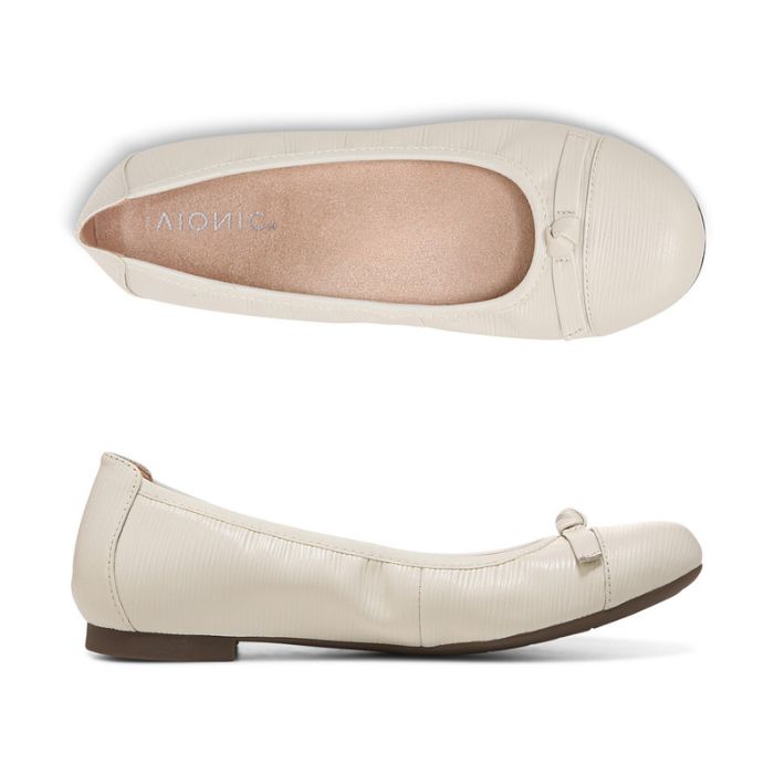 Top and side view of white ballerina flat with bow on toe. Beige footbed has Vionic logo on it.