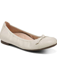 White ballerina flat with bow on toe.