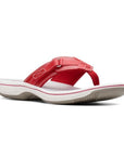 Breeze Sea thong sandal in red. Red upper featuring adjustable velcro strap and a fabric toe post. Footbed is grey, midsole is white, and outsole is taupe.