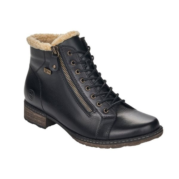 Black ankle boot with lace and zipper closure. Boot has off white faux fur collar and brown outsole.