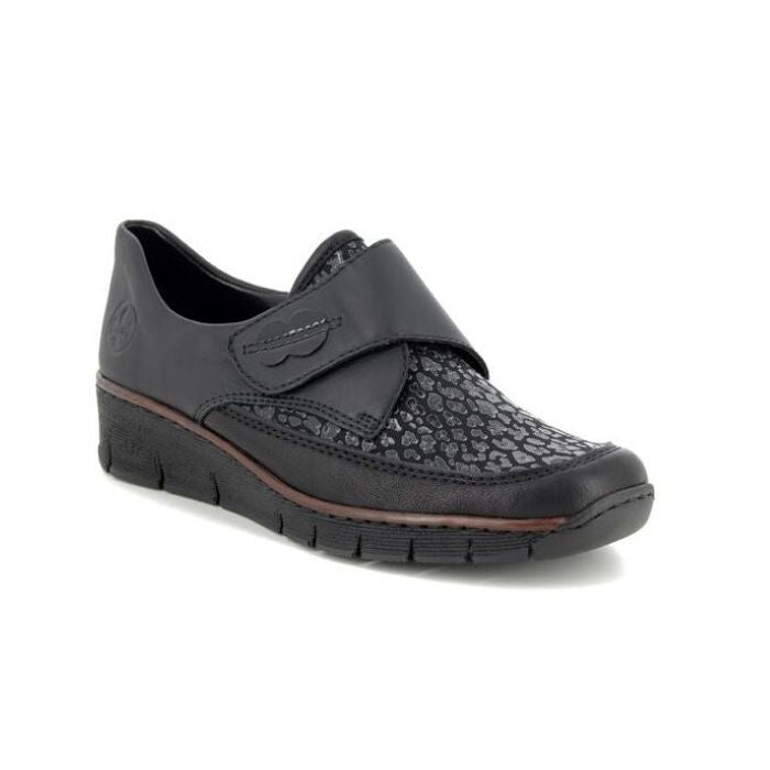 Black Slip-on casual 537C0-00 by Rieker has a cross foot velcro closure, sparkle detailing at the foot upper, slight wedge heel and brown trim line