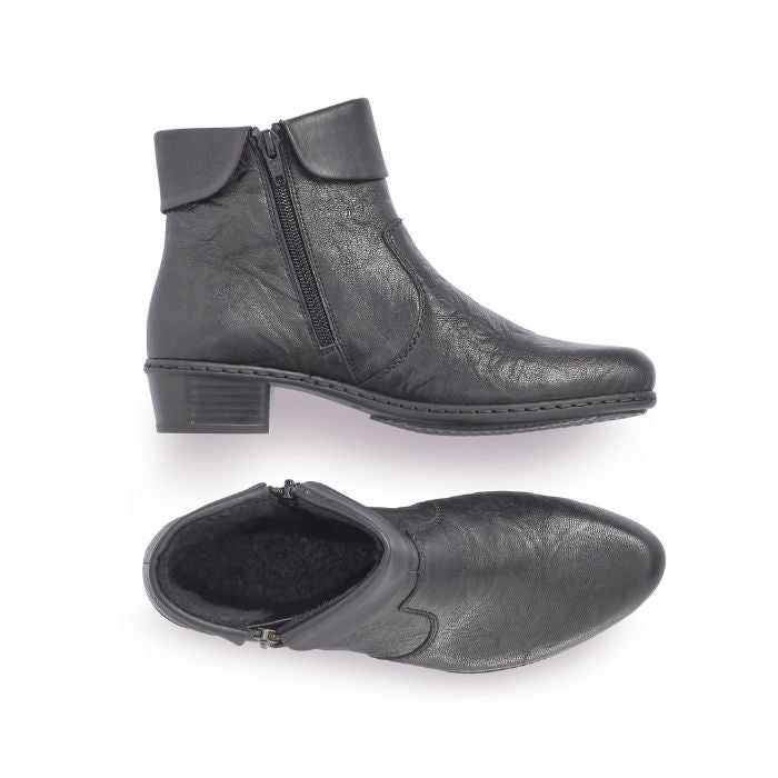 A pair of black Rieker ankle boots with  zipper, on both sides, folded down cuff, detailed stitching, and a low heel.